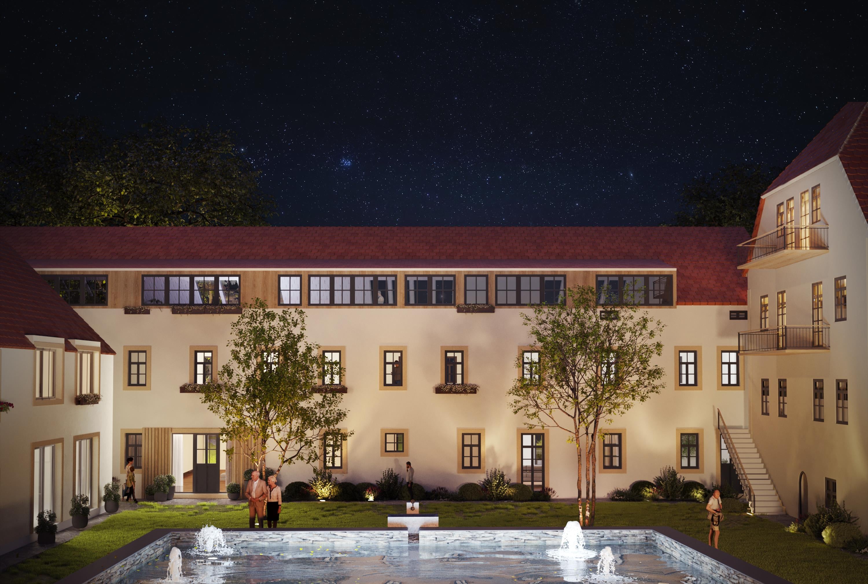 Rittergut Seifersdorf — beleuchteter Innenhof mit Brunnen bei Nacht